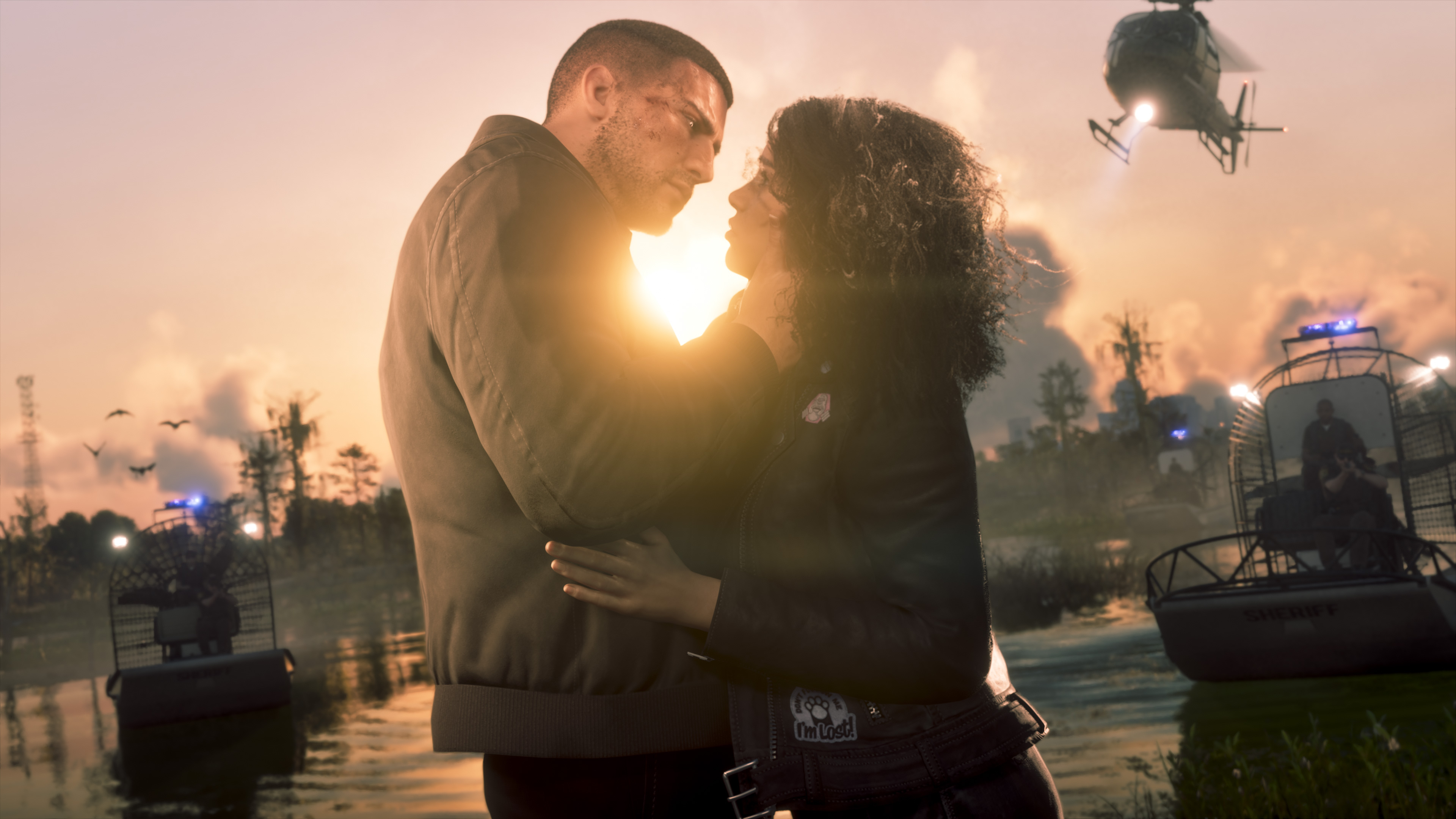Jason and Lucia embracing at sunset near the water.