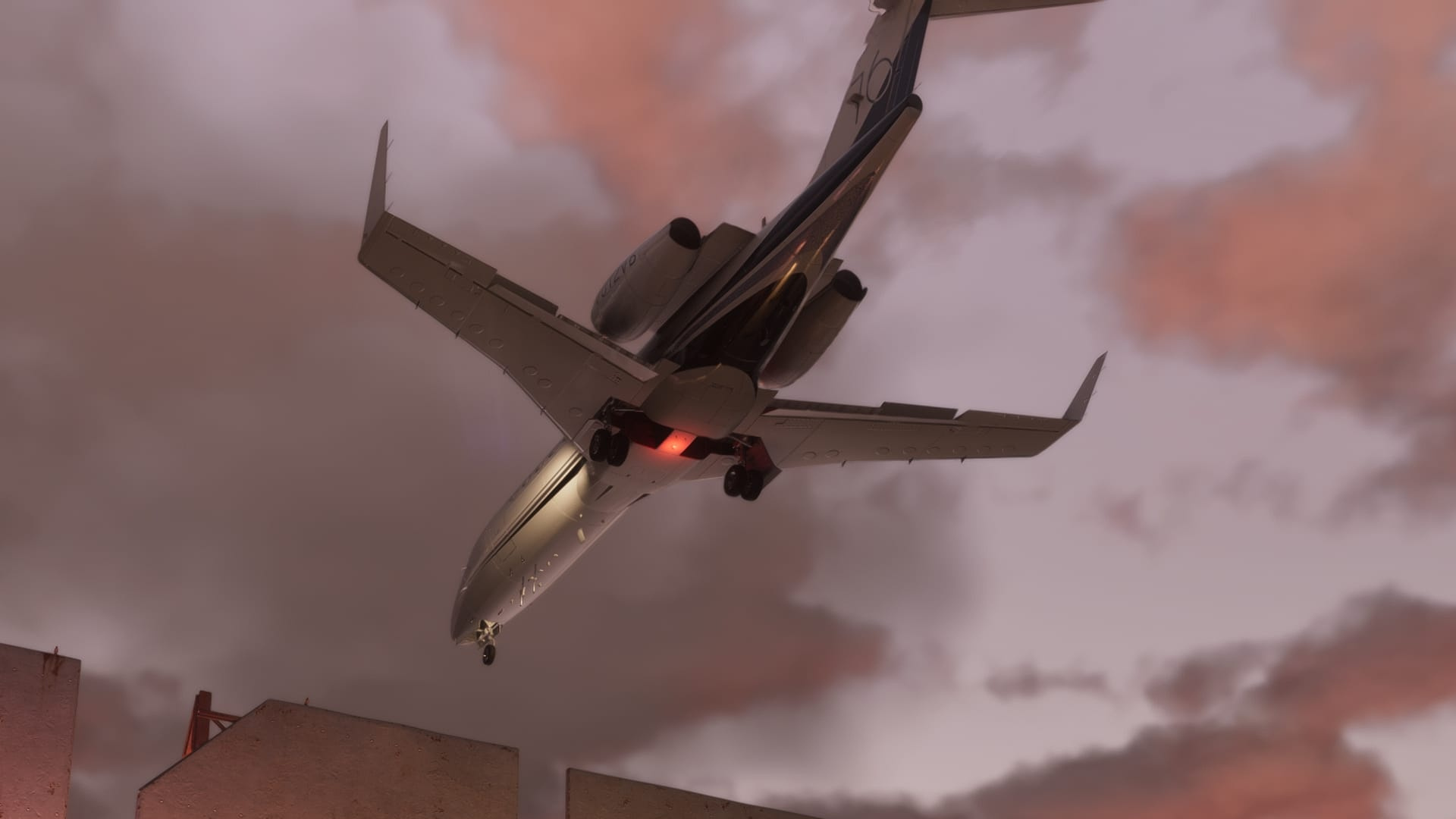 A white private jet with its landing gear down flies low at sunset