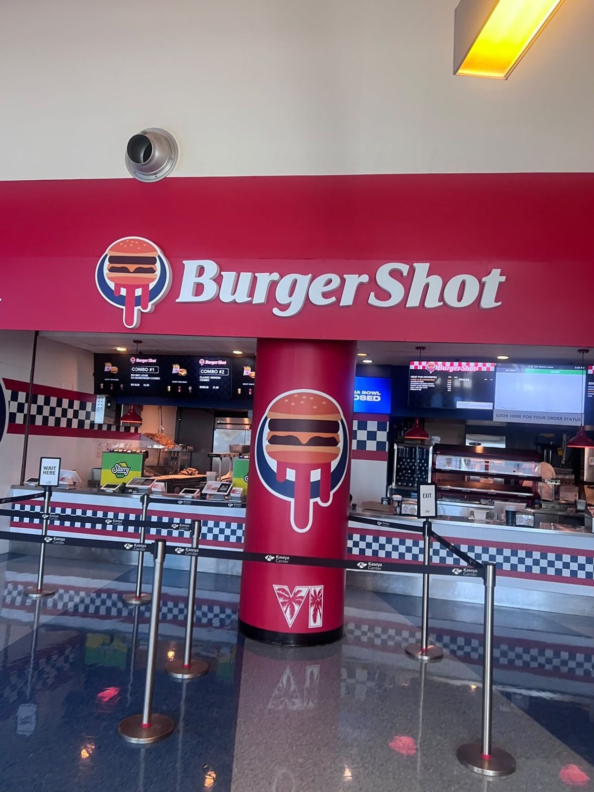 Kaseya Center concession stand in Miami with Burger Shot signage and logo, menu screens, and a red pillar bearing the GTA VI logo