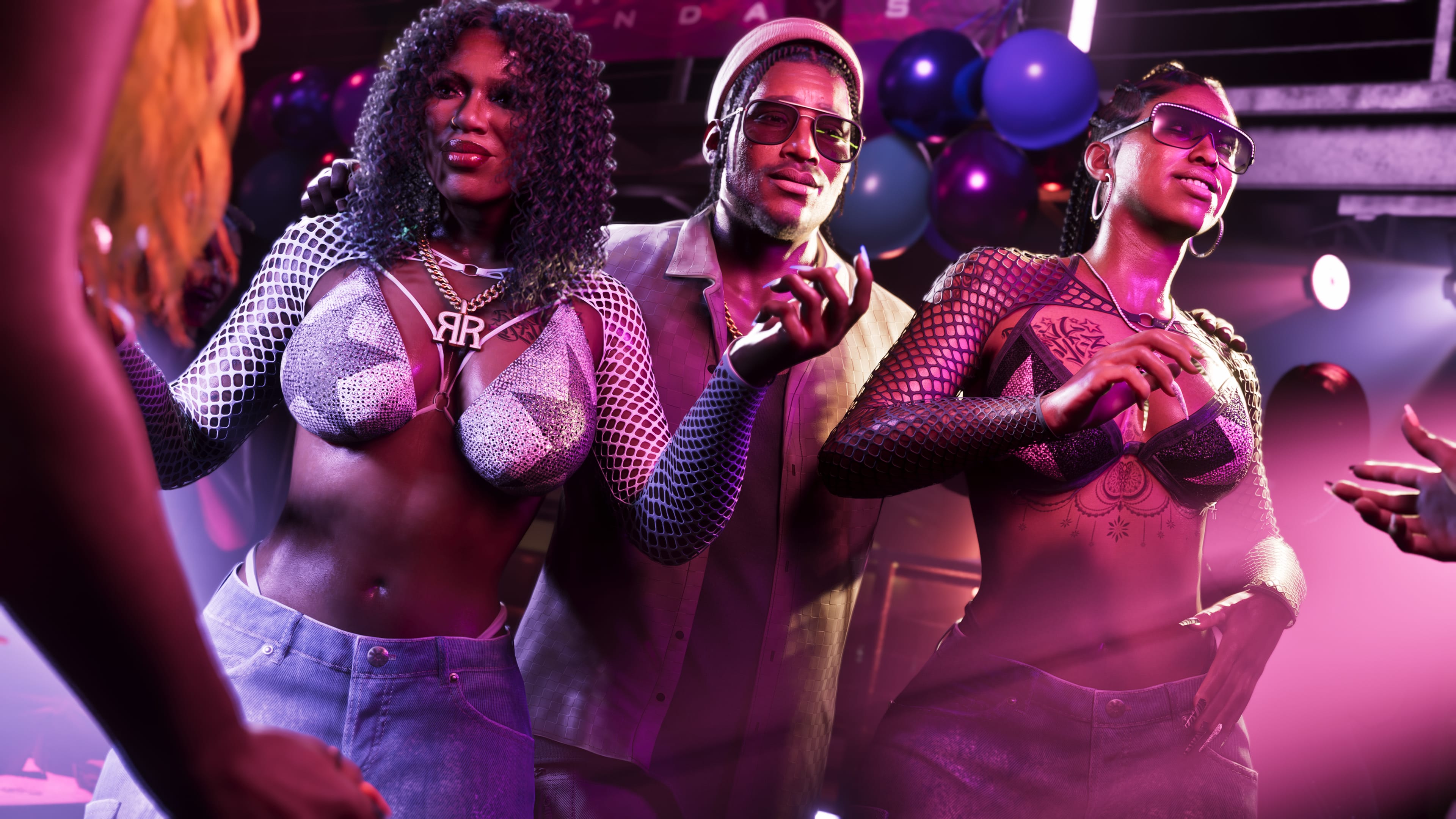 Dre'Quan Priest posing with performers in a club.
