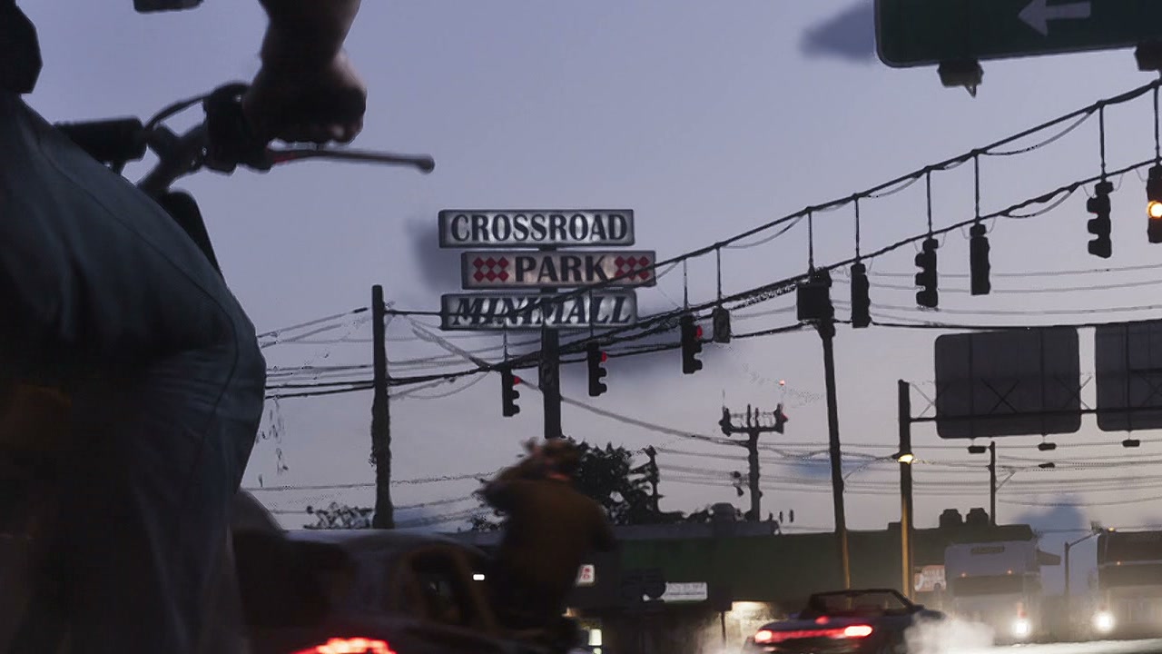 Pylon sign reading Crossroad Park Minimall against the dusk sky, with traffic lights and power lines