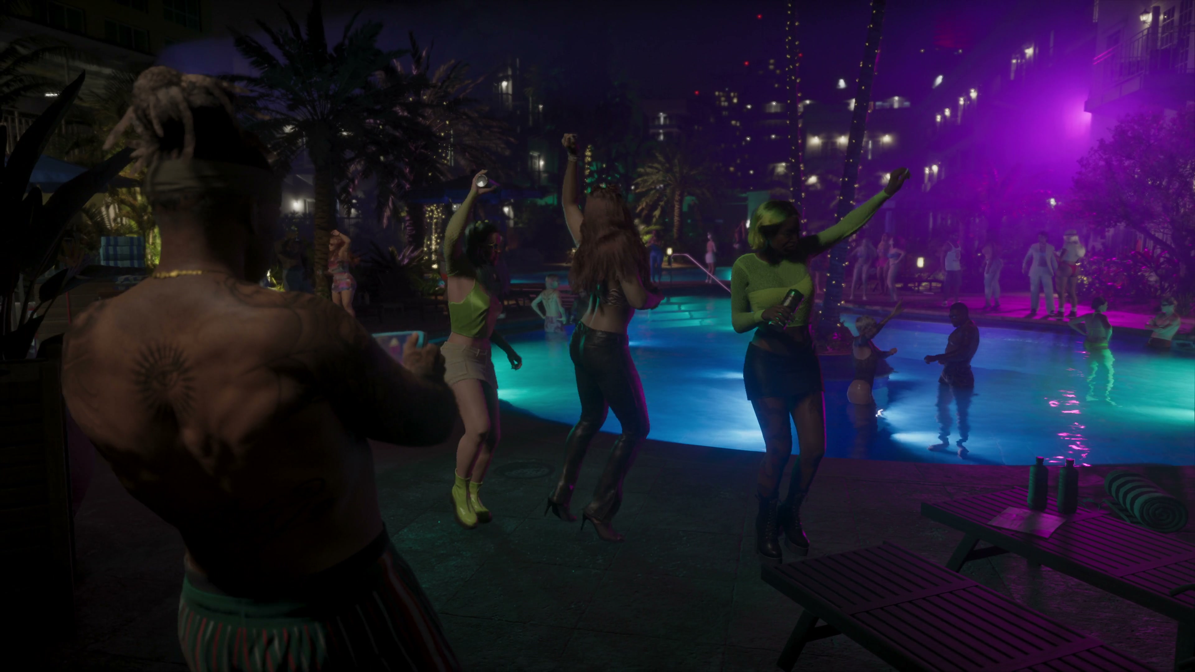 Lucia dances beside a lit pool during a nighttime party.