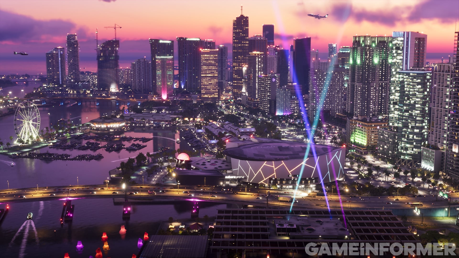 Night skyline with lit skyscrapers and colored laser beams over an event by the bay, at dusk.
