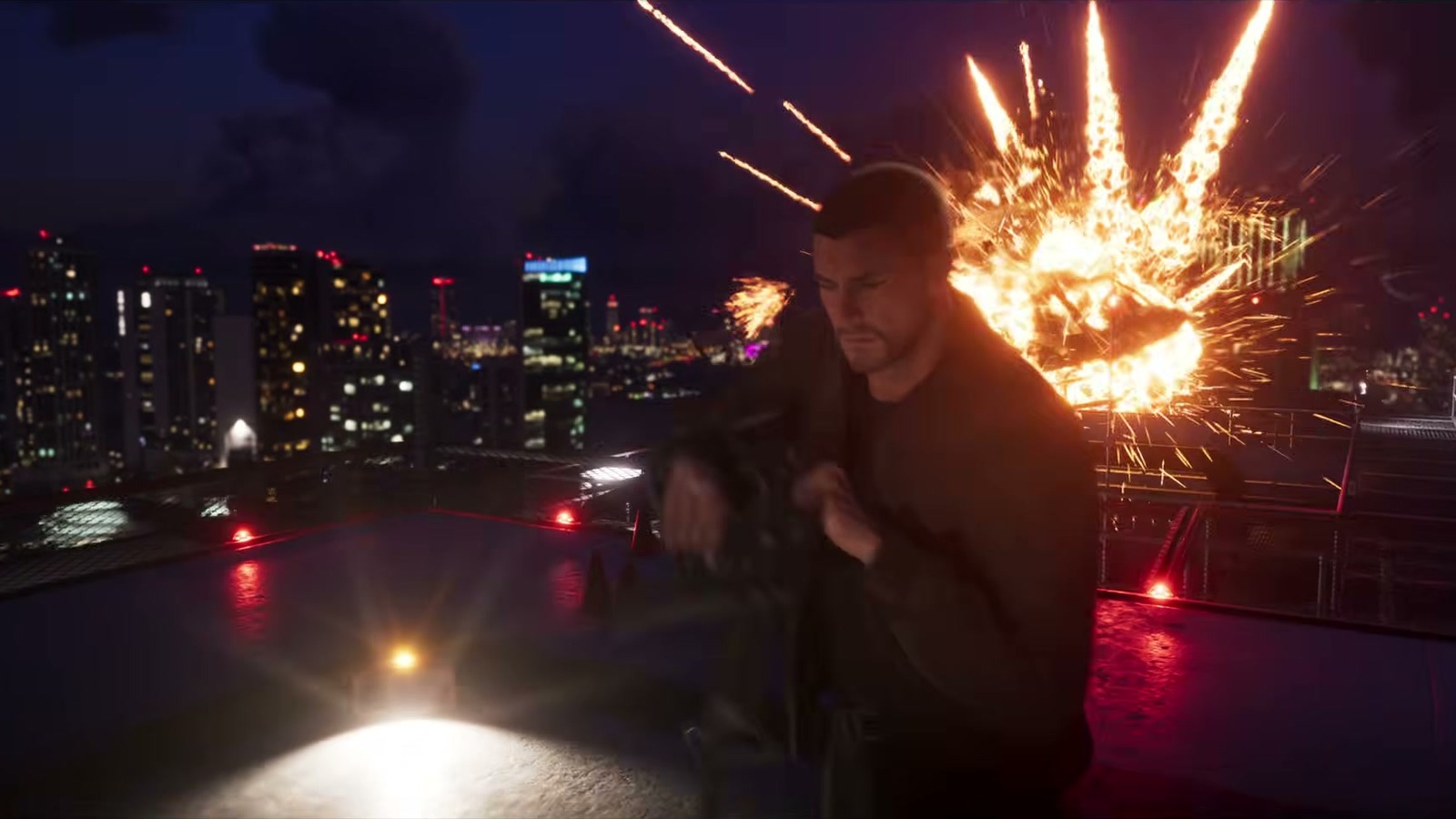 A man on a rooftop at night with a fireball and the city behind him.