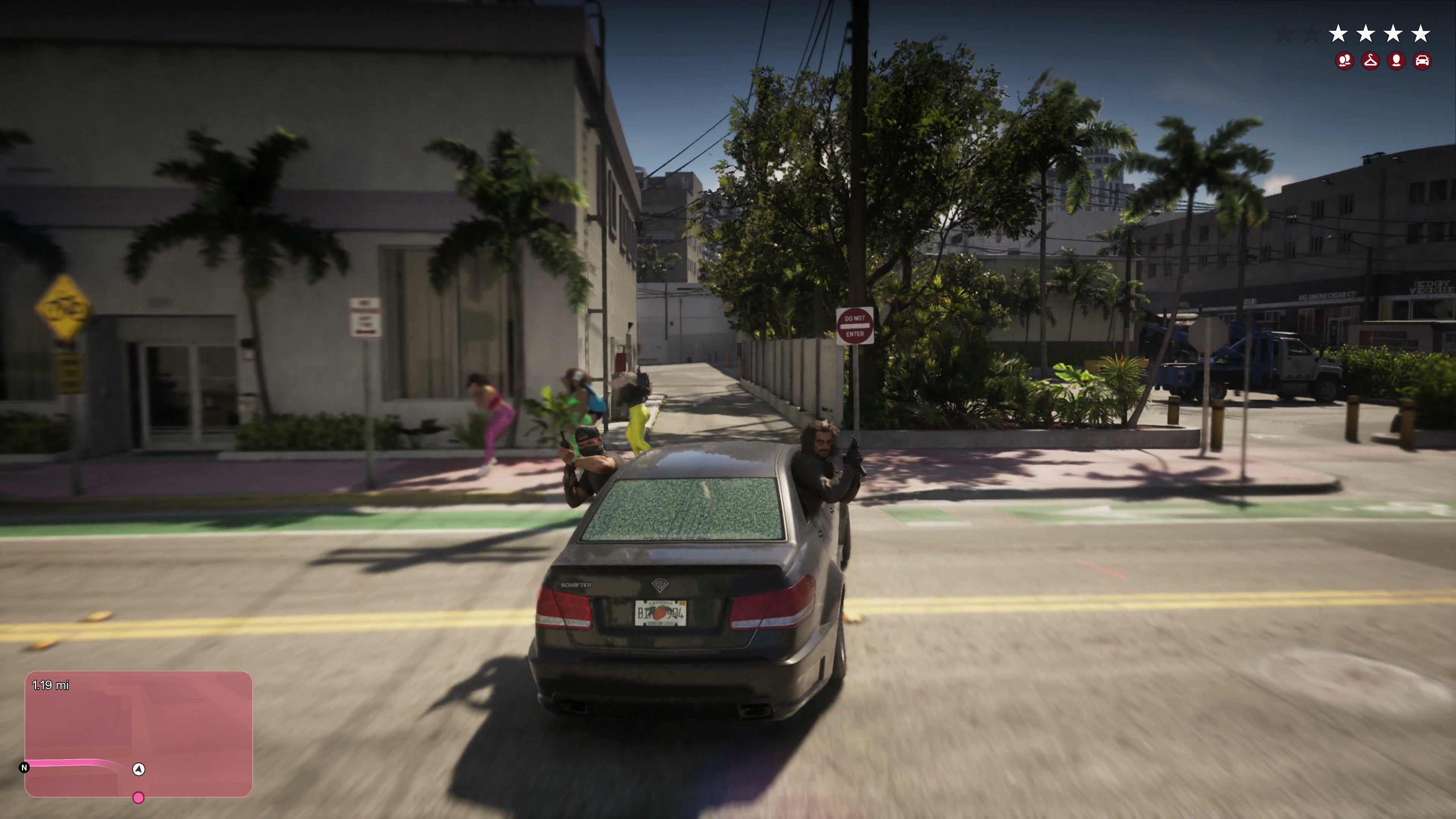 Armed passenger leans out of a moving car during a police pursuit.