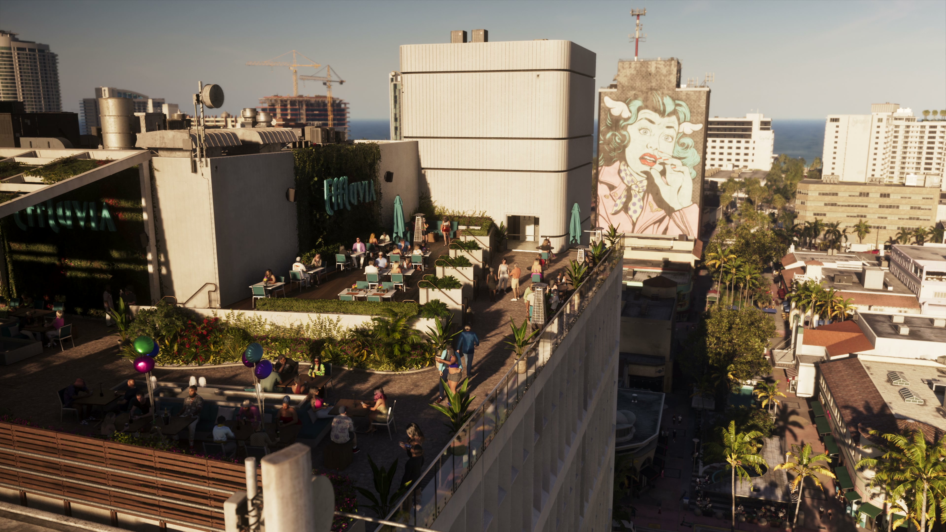 Effluvia rooftop terrace with tables, plants and a large mural of a woman on the next building