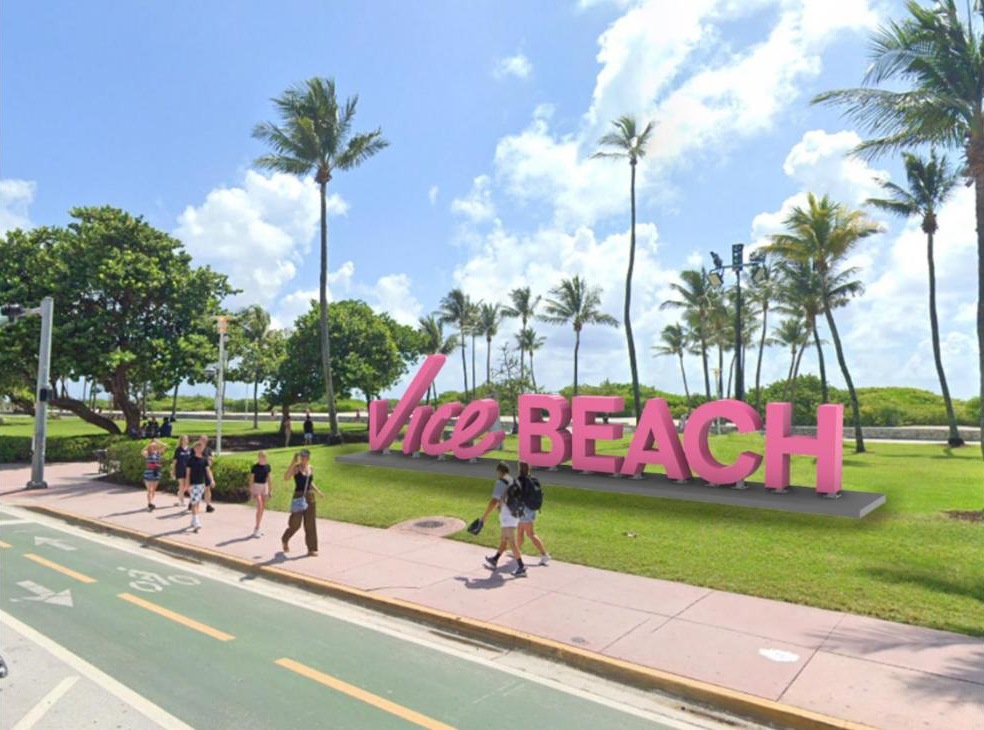 Mockup of the giant pink "Vice Beach" sign on the Lummus Park lawn next to Ocean Drive, with palm trees and passersby