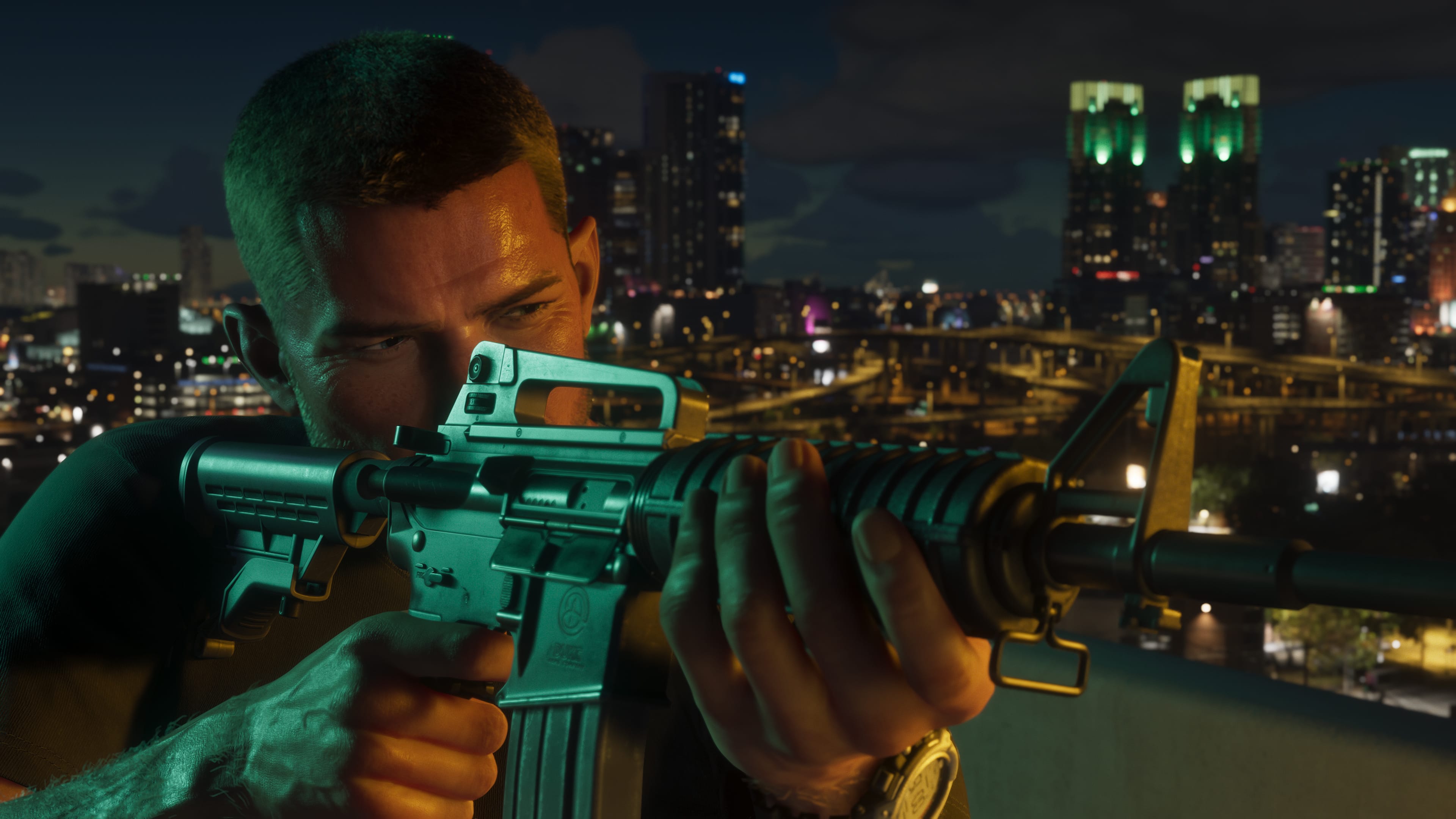 Jason aiming a rifle at night with city lights behind him.