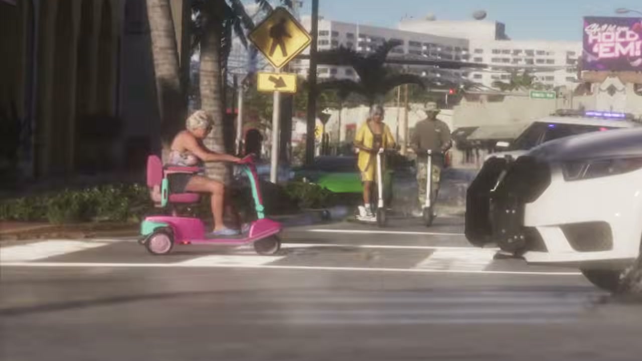 A woman crosses Shore Drive on a pink and turquoise mobility scooter