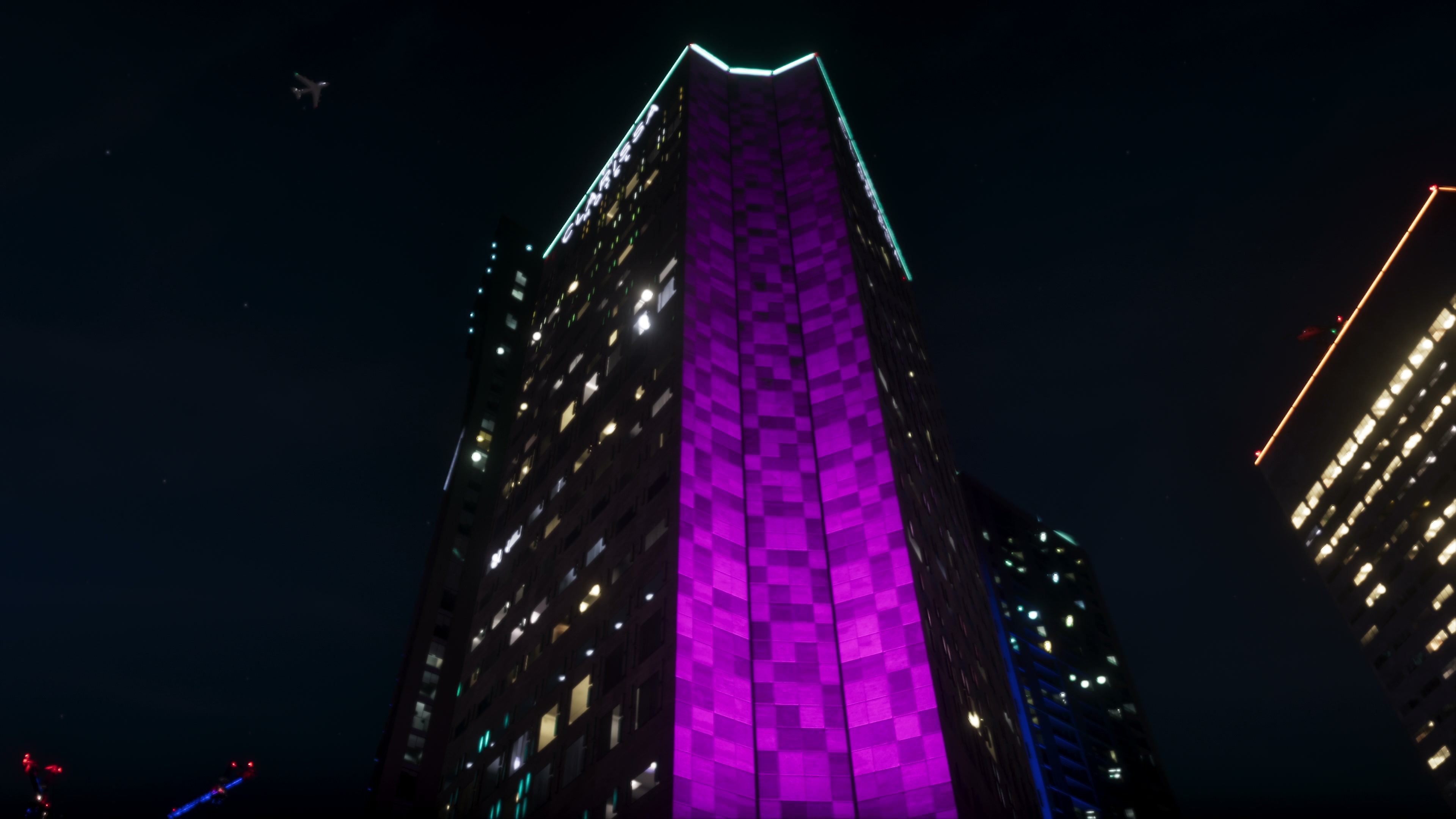Skyscraper with a lit purple checkerboard and «CLARISSA» along its crown