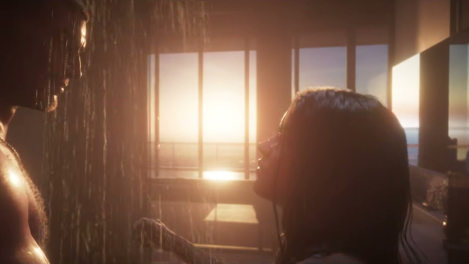 A couple face each other under a backlit shower, sunny windows behind.