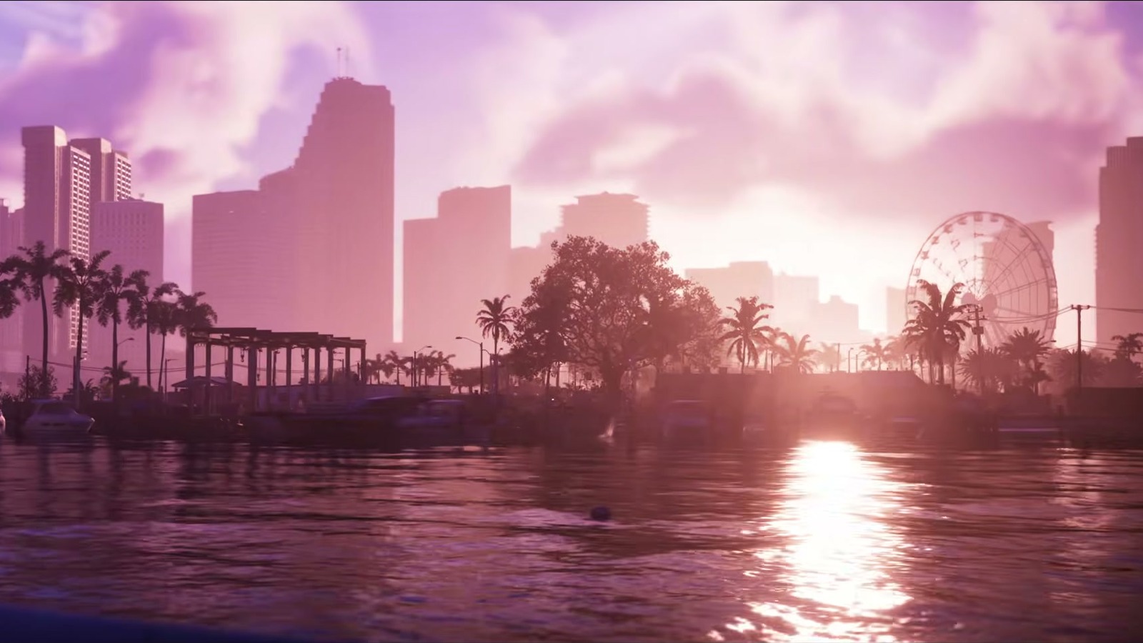 The skyline at sunset from the water, with palms and a Ferris wheel.